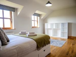 a bedroom with a large bed with two towels on it at Just Beyond Dingle in Dingle