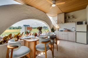 a kitchen and dining room with a table and chairs at Premaloka in Tanah Lot