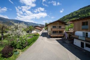 an empty road in a village with houses at Wellness Landhaus Parth in Ossiach