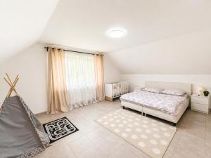 a bedroom with a bed and a large window at Atik V Borovičkách in Lipuvka