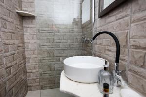 a bathroom with a sink and a faucet at Guest House Nina in Berat +62 photos