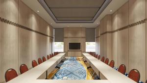 a conference room with a long table and chairs at Mövenpick Resort Carita in Serang