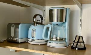 a kitchen counter with a coffee maker and a blender at Le Ptit Germain in Saint-Germain-la-Blanche-Herbe