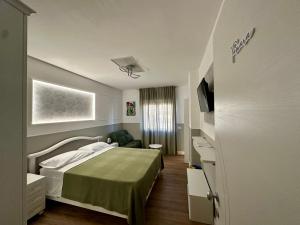 a hotel room with a bed and a couch at Blu Opèra Guest Rooms in Soverato Marina