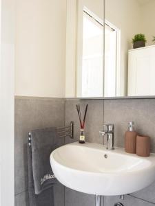a bathroom with a sink and a mirror at La Chicca Appartamento Superior Fucecchio in Fucecchio