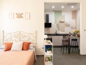 a bedroom with a bed and a small kitchen at La Chicca Appartamento Superior Fucecchio in Fucecchio