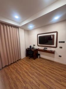 a living room with a large flat screen tv on the wall at HOTEL NILACHAL - 10 Mins Travel to Kamakhya Temple, Guwahati in Guwahati