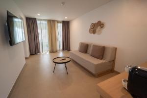 a living room with a couch and a table at HL Miraflor Suites Hotel in Playa del Ingles