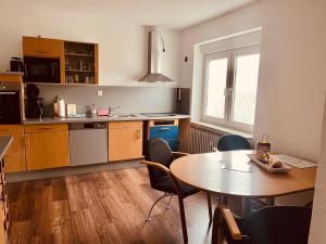 a kitchen with a table and a table and chairs at Gästehaus Gerschler in Garbsen