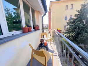a balcony with two chairs and a tea kettle on a table at Dimora le tagliate in Lucca