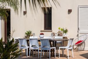 a patio with a wooden table and chairs at Villa Casale by PosarelliVillas in Bisciano