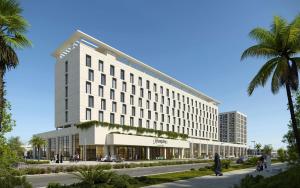 a rendering of a hotel with a palm tree at Hampton By Hilton Jeddah Souq7 in Jeddah