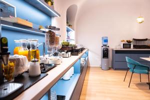 a kitchen with a counter with a bunch of appliances at Pilvax Hotel Budapest in Budapest