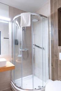 a bathroom with a shower with a glass door at Pilvax Hotel Budapest in Budapest +69 photos