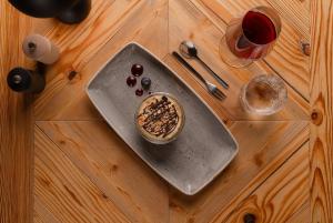 a table with a bowl of food and a glass of wine at Auenhütte in Hirschegg