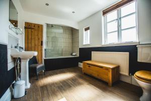 a bathroom with a sink and a toilet and a tub at No.8 Accommodation in Chepstow