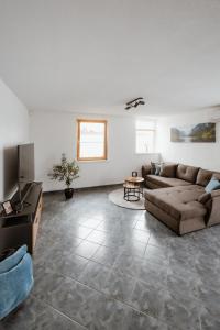a living room with a couch and a television at Riedwohnung 2 in Lustenau