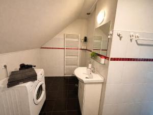 a bathroom with a washing machine and a sink at Atik V Borovičkách in Lipuvka