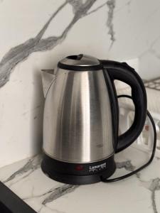 a black and silver tea kettle on a counter at Sweet Escape Varna in Varna City +14 photos