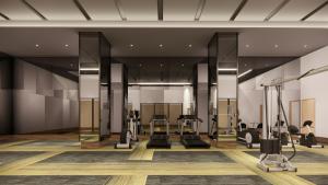 a gym with treadmills and elliptical machines at Mövenpick Resort Carita in Serang