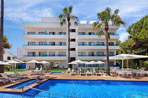 a hotel with a swimming pool and palm trees at Metropolitan Juka Playa in Playa de Palma