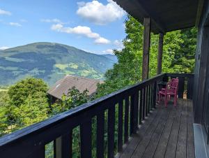 a deck with two chairs and a table on it at artlodge TinyHouses in Treffen