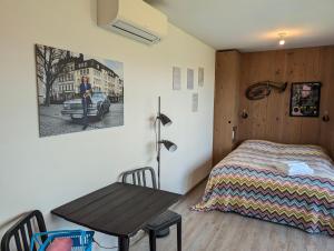 a bedroom with a table and a bed and a table and chair at artlodge TinyHouses in Treffen