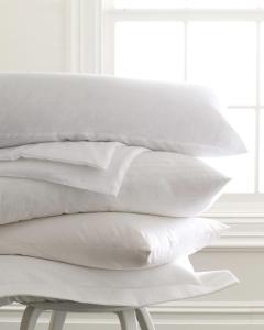 a pile of white pillows sitting on a bed at Sheraton Rockville Hotel in Rockville