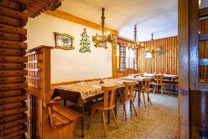 a dining room with wooden tables and chairs at Rifugio Capanna Bill in Rocca Pietore