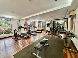 a gym with several treadmills and exercise bikes at Subtlestays in Arpora +2 photos