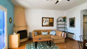 a living room with a couch and a coffee table at Pink Villa in Porto Heli