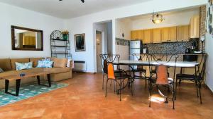 a kitchen and a living room with a table and chairs at Pink Villa in Porto Heli