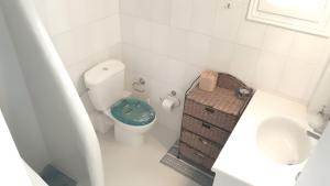 a small bathroom with a toilet and a sink at Pink Villa in Porto Heli +16 photos