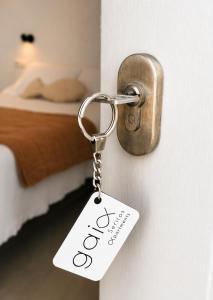 a key chain with the word open on a bedroom door at Gaia Serifos Apartments in Rámos +44 photos