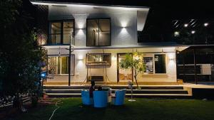 a house at night with its lights on at Angel Garden Farmhouse in Noida