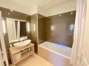 a bathroom with a sink and a bath tub at Duplex equipped for 6 people in Jausiers +8 photos
