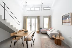a living room with a couch and a table at Lixouri Square Loft in Lixouri