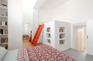 a bedroom with a bed and a book shelf at Lixouri Square Loft in Lixouri