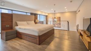 a bedroom with a bed and a balcony at Luxury Duplex & Apartment Pentstudio - Tay Ho Hanoi in Hanoi