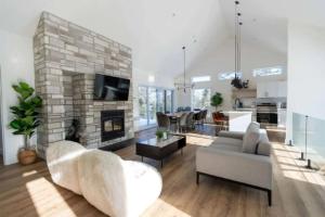 a living room with a couch and a fireplace at Spa & Sauna Pool Table & Game Room - Le Perche in Brownsburg