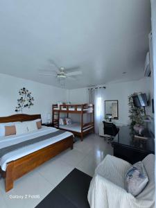 a bedroom with a large bed and a desk at The beach house, Baroro Beachfront Villa in Bacnotan +43 photos