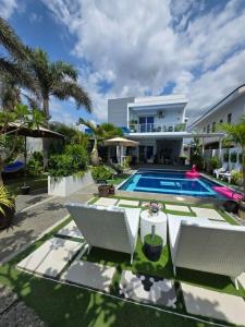 an image of a house with a swimming pool at The beach house, Baroro Beachfront Villa in Bacnotan