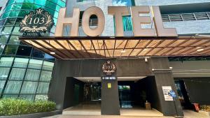 a hotel sign on the front of a building at 103 Hotel by manatidur in Kuala Lumpur