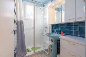a bathroom with a sink and a shower at Sweet Villa Burgundy in Dijon
