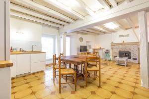 a kitchen and dining room with a table and chairs at La Cabotte d'Ahuy in Ahuy