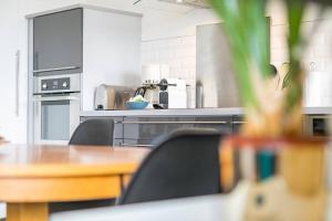 a kitchen with a table and chairs in a kitchen at La Parenthèse in Dijon