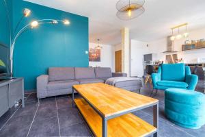 a living room with a couch and chairs and a table at La Parenthèse in Dijon