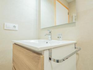 a bathroom with a white sink and a mirror at YBH Villa Lara in Villanueva de Arosa +280 photos