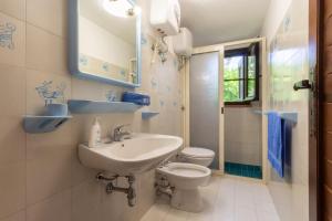 a bathroom with a sink and a toilet at Villa Terry in Marongiu +24 photos