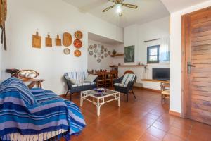 a living room with a couch and a table at Villa Terry in Marongiu